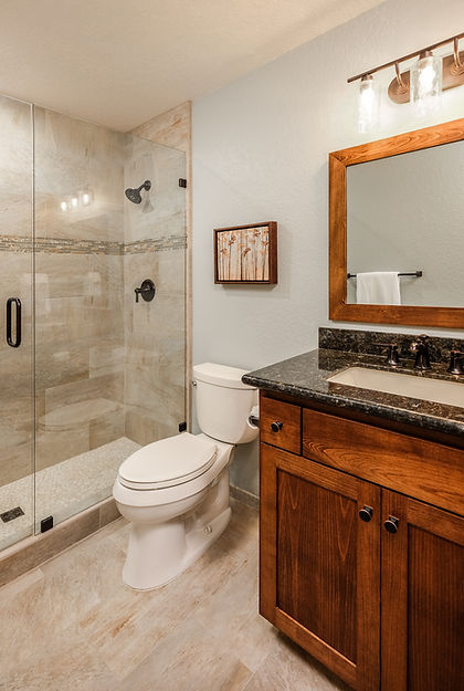 Contemporary guest bathroom with wood framed mirror