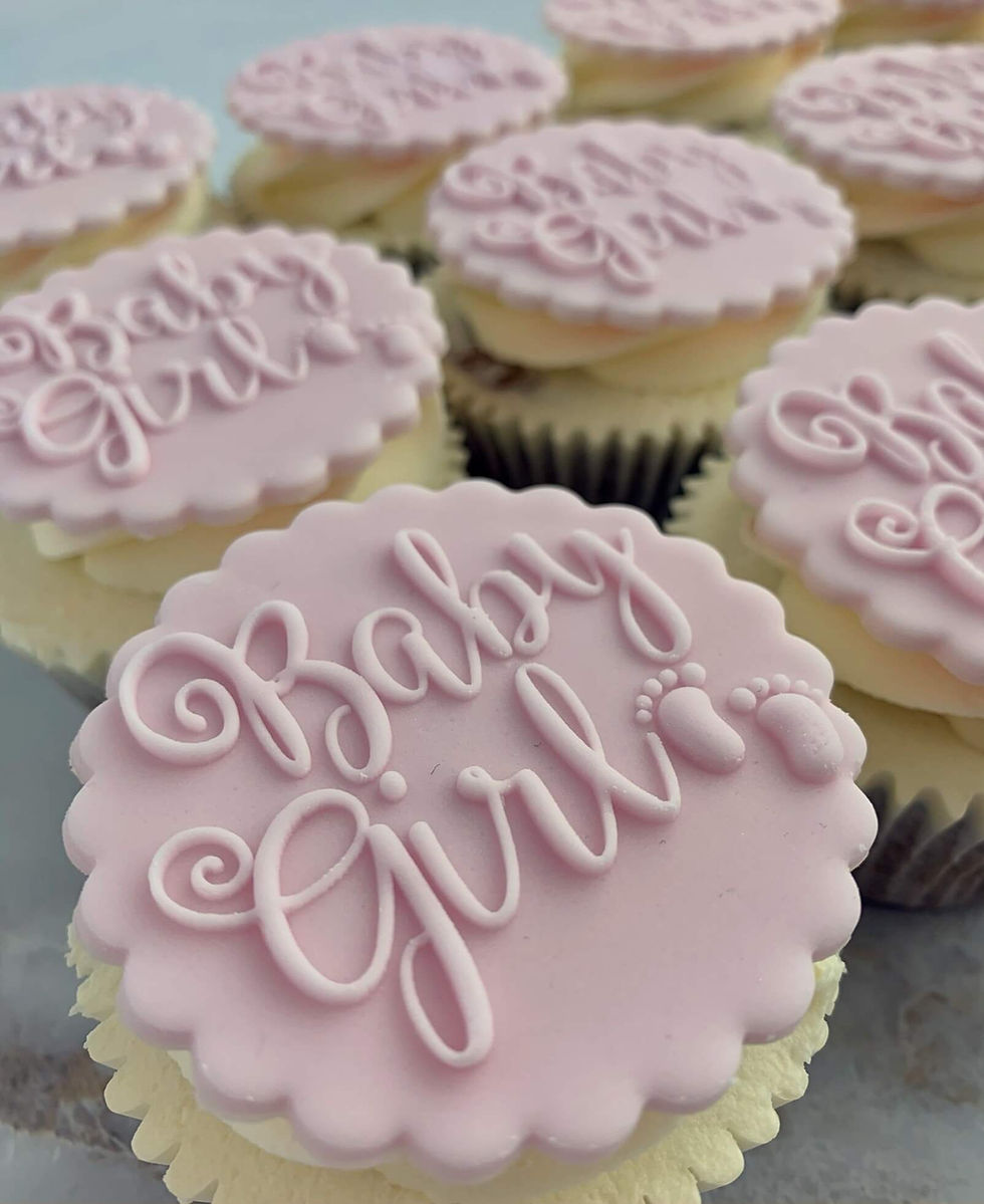 Thumbnail: pink baby girl cupcakes with a fondant topper