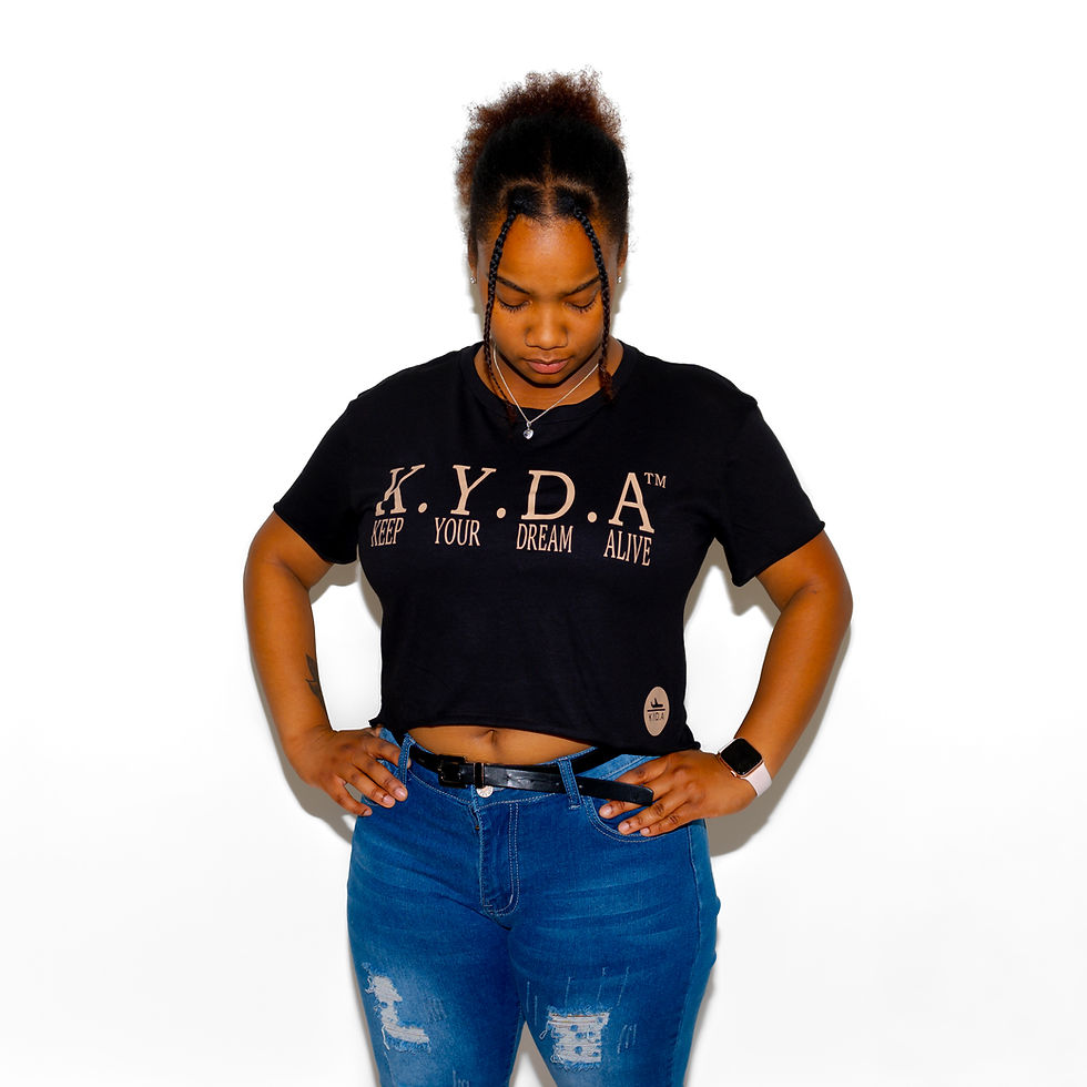 Model Wearing Black Cropped T-Shirt with Tan "KEEP YOUR DREAM ALIVE" Design