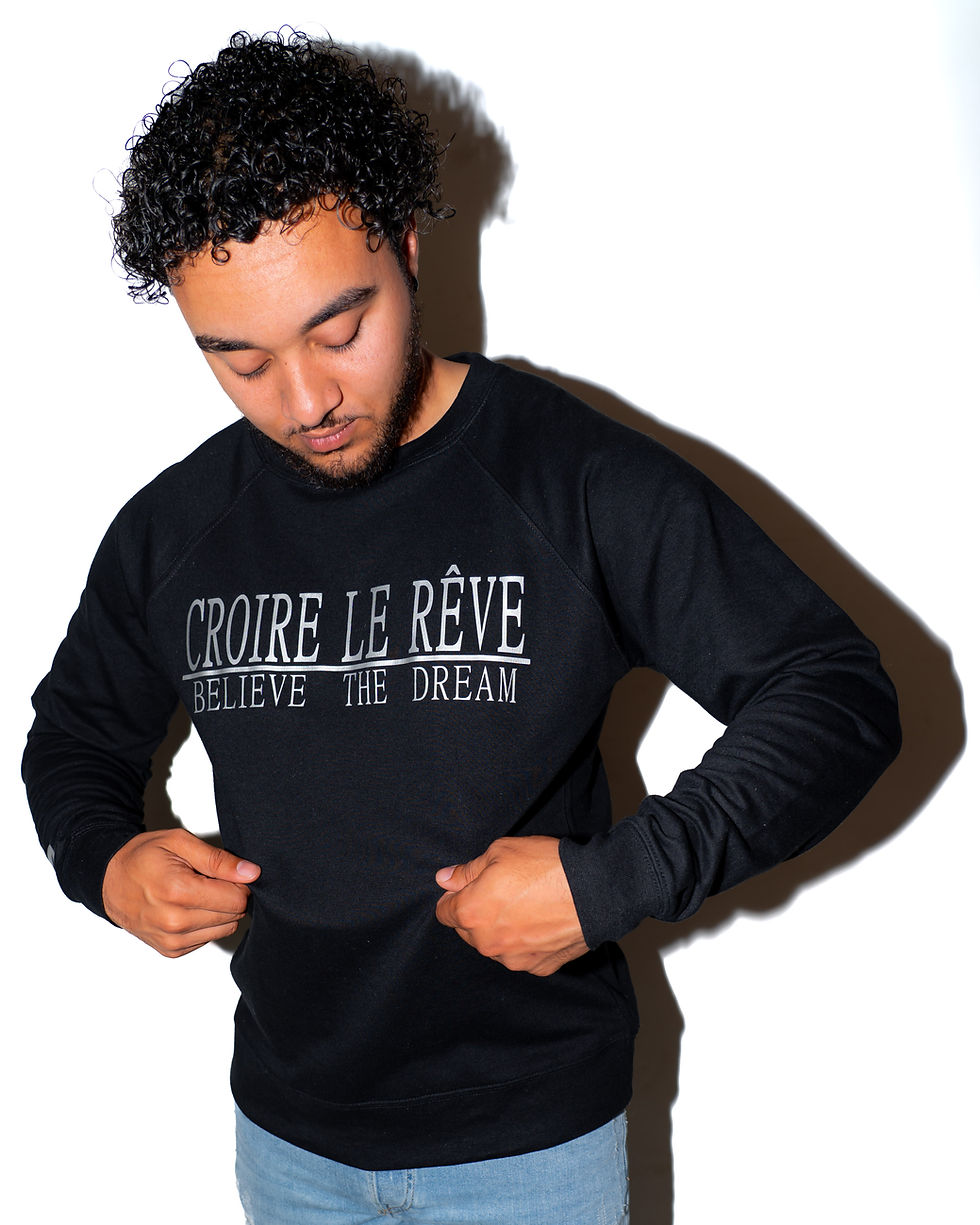 Model Wearing Black Crewneck with Silver "CROIRE LE REVE" Design