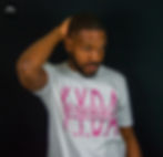 Model wearing white and pink "K.Y.D.A IN THE MIDDLE" T-Shirt