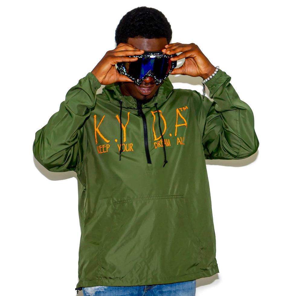 Model Wearing Green Windbreaker with Orange "KEEP YOUR DREAM ALIVE" Design