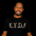 Model wearing black, silver, and orange "K.Y.D.A BLOCKED" T-Shirt
