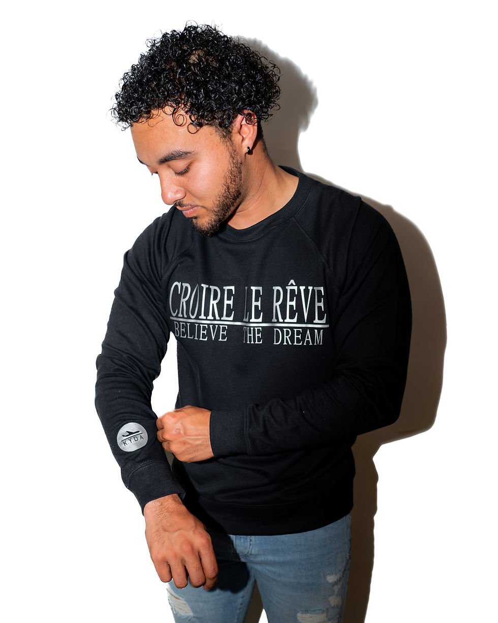Model Wearing Black Crewneck with Silver "CROIRE LE REVE" Design