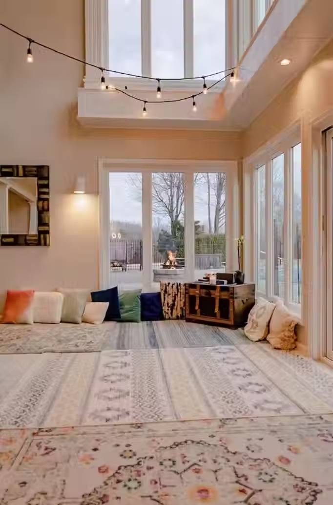 A low, comfy sofa covered in mismatched cushions. A sun-faded rug that softens the floor.