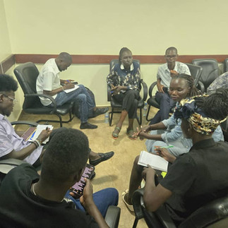 group of people discussing and taking notes
