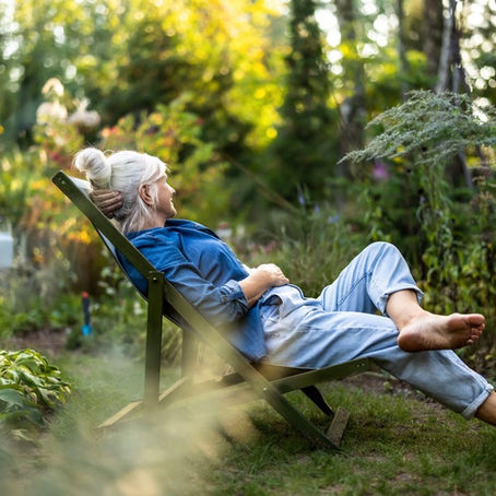 A woman relaxing in a garden.