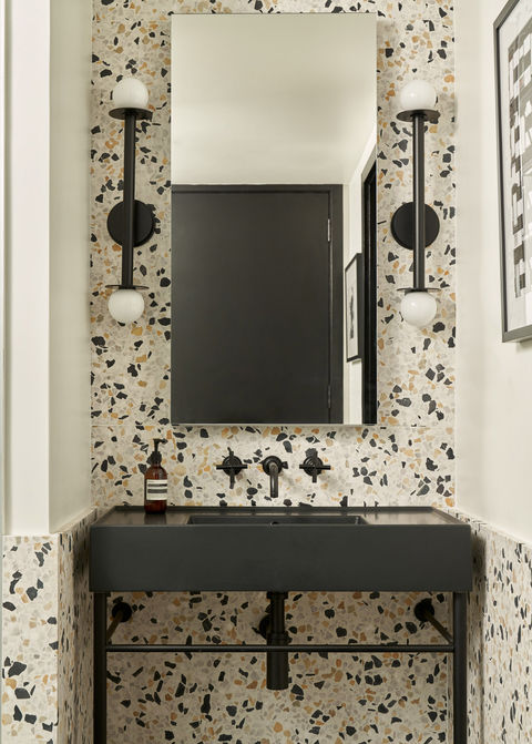 Splatter wallpaper and black furniture accents design