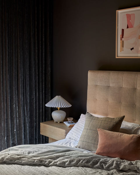 Moody bedroom design with velvet accents.
