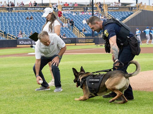VFR Founder David Knott and K9 Officer Chinook throw out the first pitch on National VFR Day