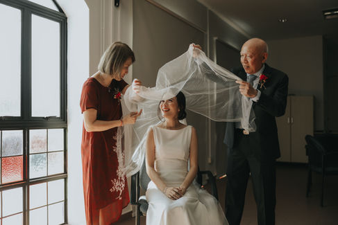 Actual day wedding photoshoot at Bethel Presbytherian Church in Singapore, featuring a couple attending their marital church service surrounded by friends and family. Photographed by Bridelope Productions.