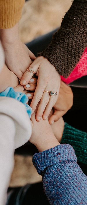 girl friends hands piled togethger_edite