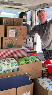 John Fitzgerald loading van for refugees