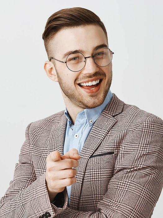 Friendly man in glasses and blazer pointing