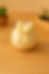 White candle with bow, sitting on a wooden table, Panda Products