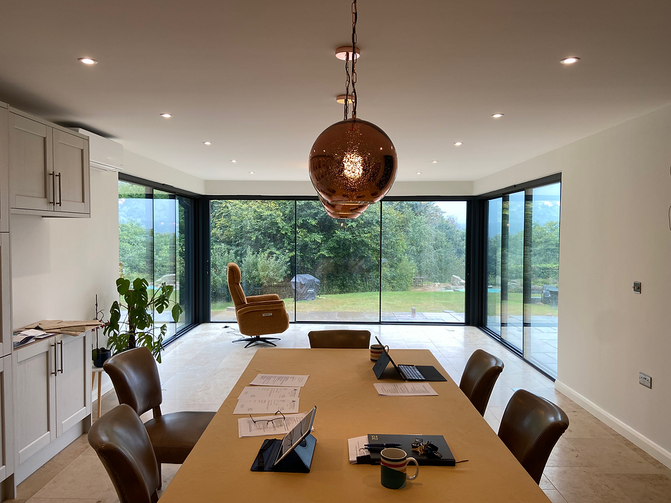 Interior space with layered lighting including pendant lights, wall lights and under-cabinet illumination.