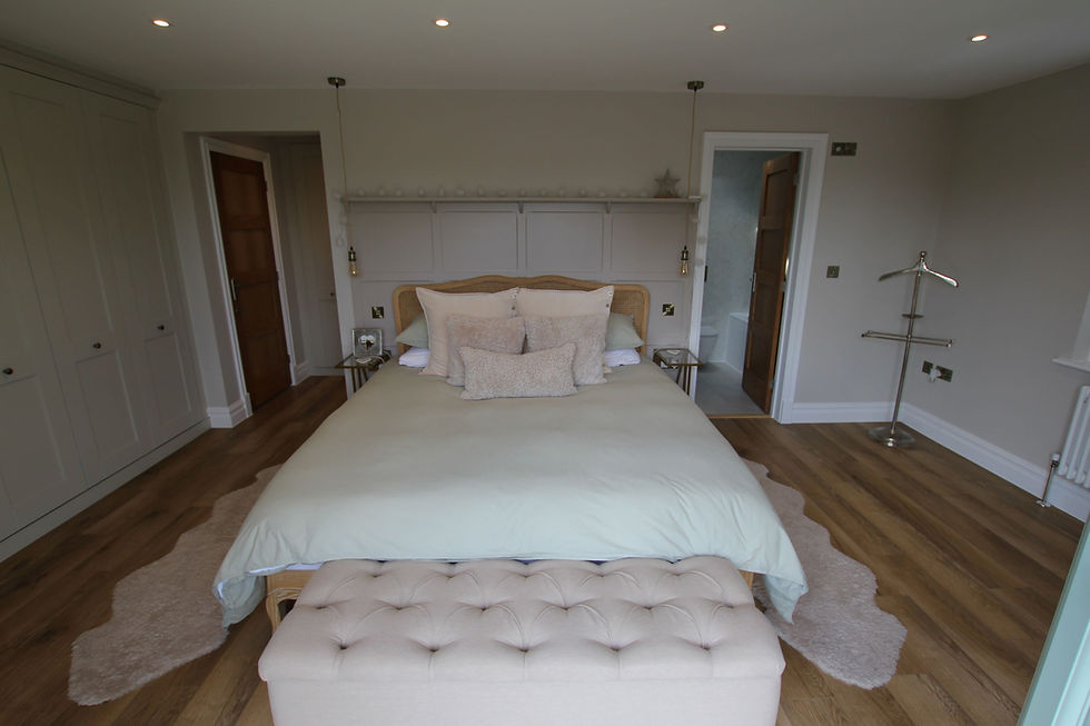 Contemporary ground-floor bedroom with en suite and wide access, designed to support aging in place in a Sussex home.
