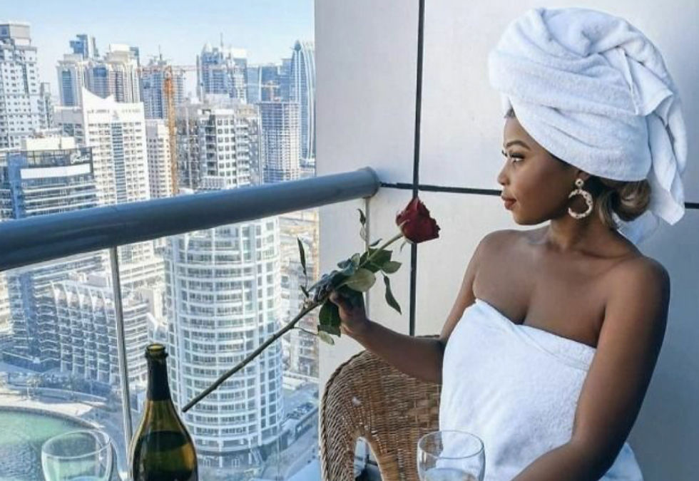 black woman smelling rose