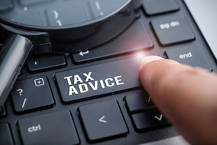 Finger on laptop keyboard written Tax Ad