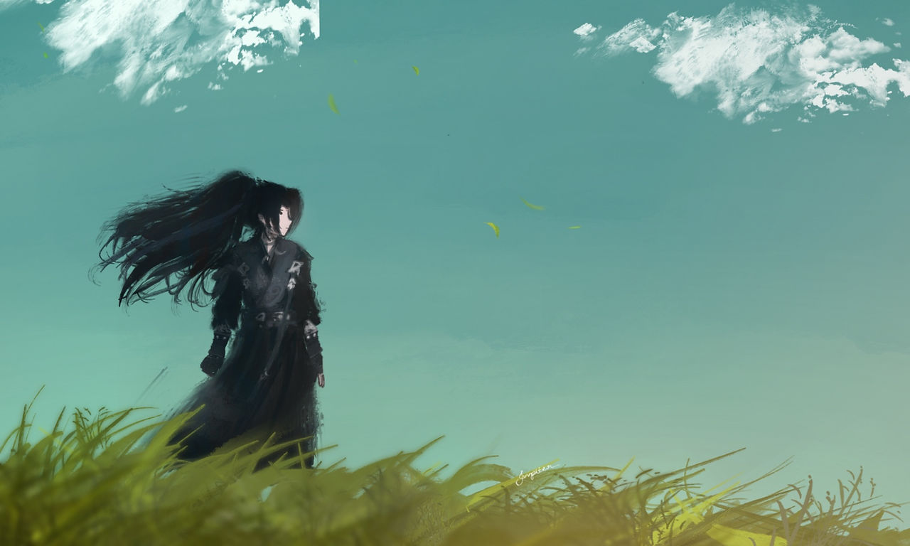 A girl stands under a blue sky, she has long dark hair and is wearing black, standing ongrass 
