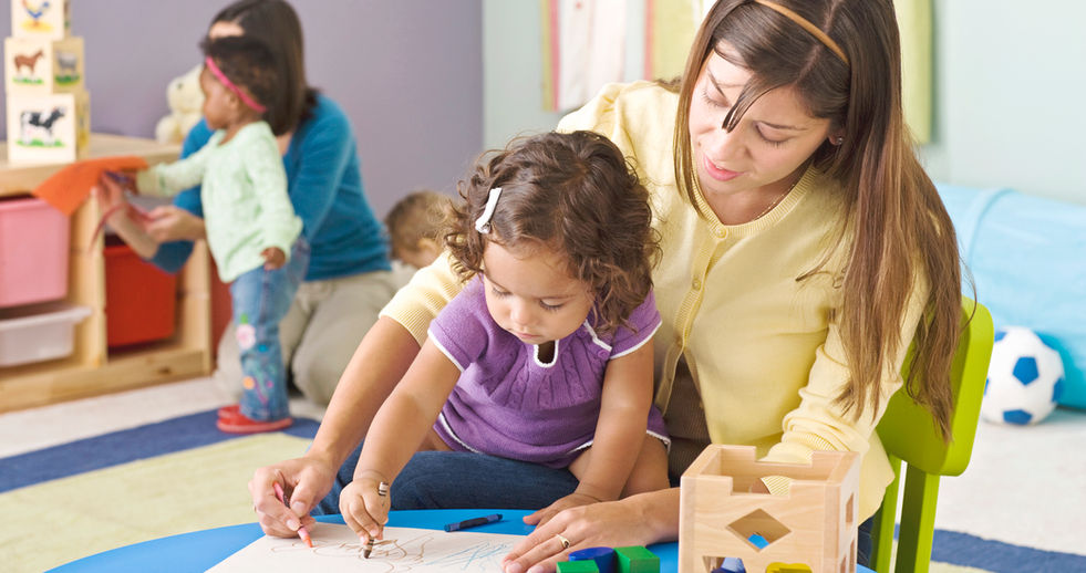 Mother helping child with art project in Boca Raton