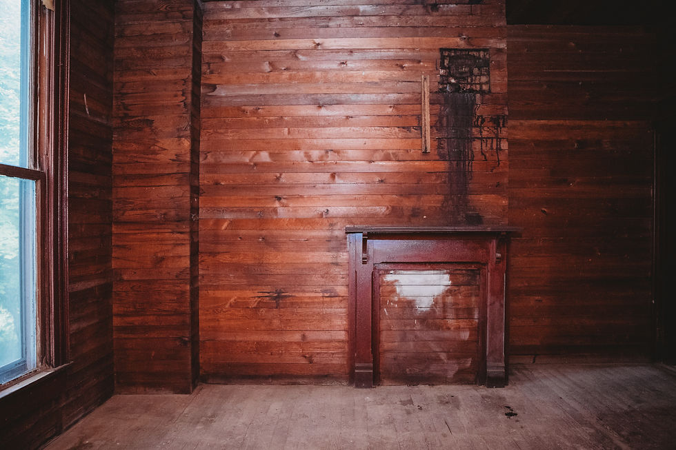 Second story room with original walls, simple mantel, and markings on wall in 1898 Victorian farmhouse