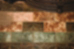 Close-up of original Victorian fireplace tile with green, pink, and cream tones used as color inspiration in a restored 1898 farmhouse