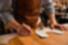 close-up-male-shoemaker-cutting-leather-textile.jpg