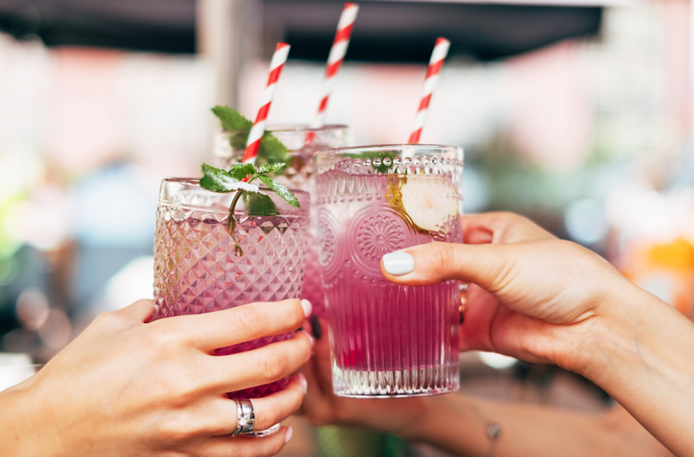 Raising a toast with vibrant adaptogenic beverages, adorned with fresh mint and cucumber slices, for a refreshing and wellness-focused celebration.