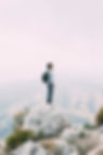 A Mascote Camper Standing atop a mountain as a leader.