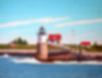 Lighthouse by the sea with red-roofed buildings in a tranquil coastal setting. Waves crash gently, blue sky with wispy clouds above.