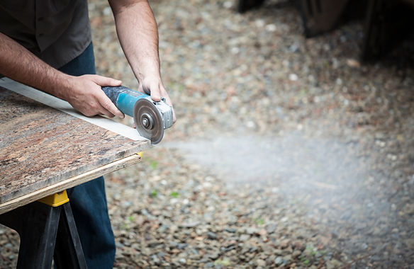 Man grinding stone slab
