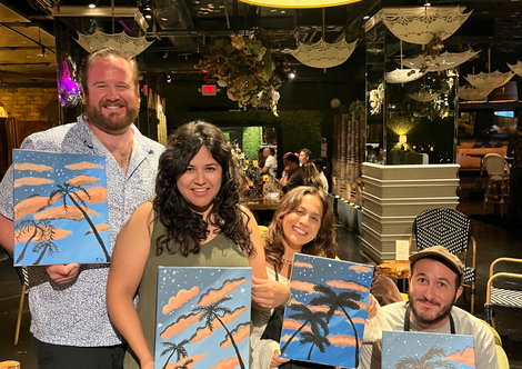 Students from paint and sip class in San Diego posing for photo