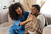 giving-warm-plaid-caring-curly-nurse-wearing-uniform-giving-warm-plaid-patient-after-catch