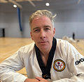 Man in a white martial arts dobok at Tan'Gun Martial Arts academy