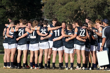 Berwick Football Mens Reserves in a huddle with coaches