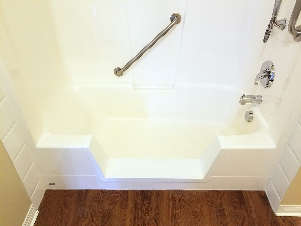 Walk-in shower with safety bar installed