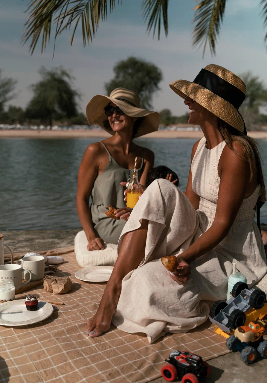 Friends gathered for a Dubai picnic experience by PicnicTimes, enjoying nature and genuine connection.