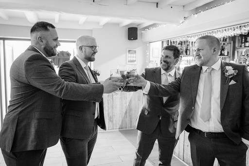 groom and groomsmen have a drink before the ceremony at ashton lodge country house wedding photography