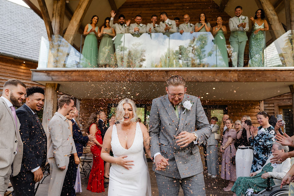 Candid moment of guests celebrating with confetti at a Staffordshire countryside wedding.