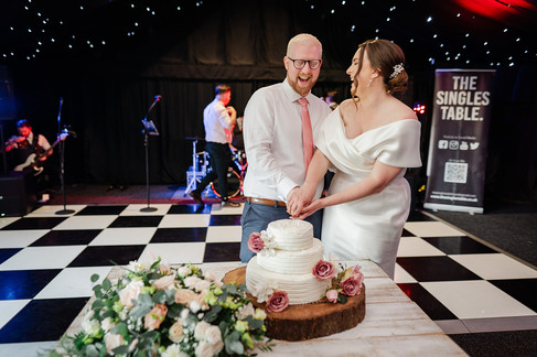 bride and groom cake cutting photo at ashton lodge country house wedding photography