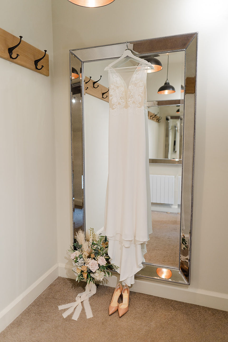 Detail photo of wedding dress, bouquet and shoes at The Ashes Barns wedding venue Stoke-on-Trent