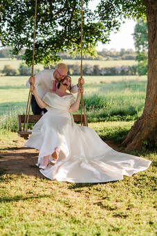 bride and groom relaxed, fun, romantic photos on the garden swing ashton lodge country house wedding photography