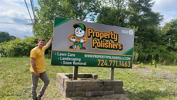 Guy Standing Beside a Property Polishers Bill Board