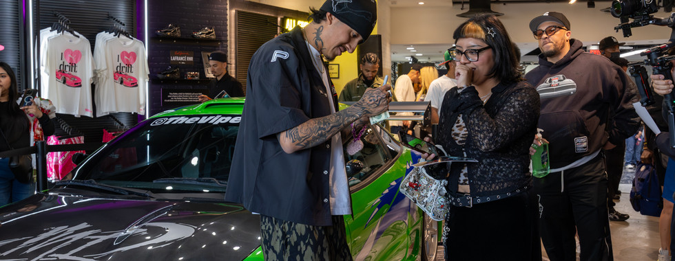 Female fan looks shocked as artist cuco signs piece of paper