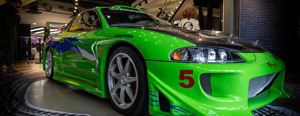 Green race car parked inside shoe palace in Los Angeles