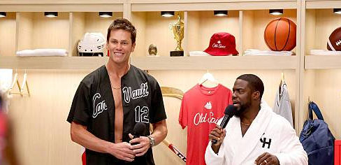 Tom Brady and Kevin Hart share a laugh on set during a taping of "Cold As Balls" at Fanatics Fest NYC, blending sports, comedy, and ice-cold competition.