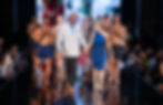 Designer and guest walk hand in hand down the runway with male swimwear models applauding behind them during Miami Swim Week 2026 Powered by Art Hearts Fashion.