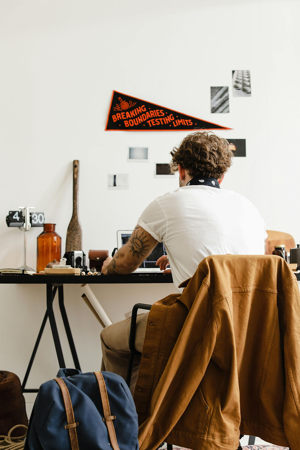 Remote worker sitting at a desk in a home office while working on a laptop.