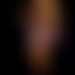 Justin Bieber playing an electric guitar onstage under dark lighting, wearing minimal stage attire, with tattoos visible during the live 68th Grammy Awards show. Photo: Kevin Winter/Getty Images for The Recording Academy